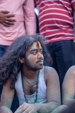 Varanasi, Uttar Pradesh, India - March 21, 2024: Masan Holi, Masan Holi, Group of unidentified devotees participating in masan holi festival at manikarnika ghat of varanasi with colours.