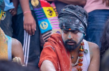 Varanasi, Uttar Pradesh, India - March 21, 2024: Masan Holi, Masan Holi, Group of unidentified devotees participating in masan holi festival at manikarnika ghat of varanasi with colours.
