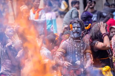 Varanasi, Uttar Pradesh, Hindistan - 21 Mart 2024: Masan Holi, Harishchandra ghat 'ta düzenlenen kutlama sırasında Lord Shiva gibi giyinmiş kuru külle boyanmış yüzü olan bir dindar..