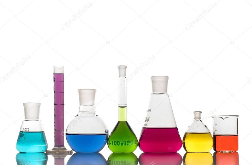 Laboratory glassware with colorful liquids and chemicals on white background