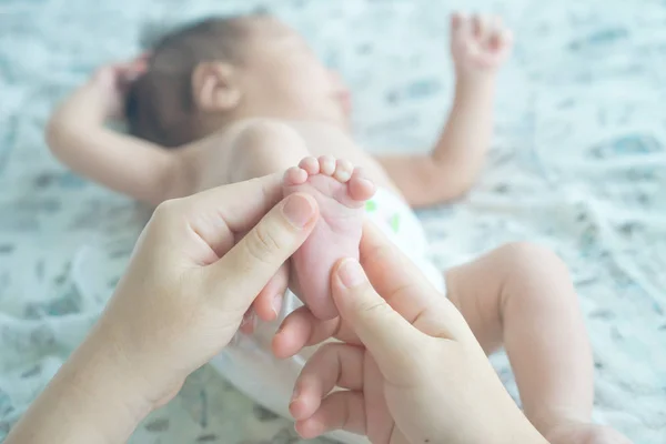 母亲为他的脚上的一个男婴做按摩 — 图库照片
