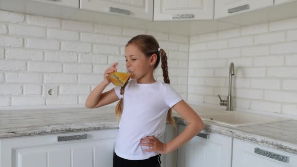 Good morning. little girl drinks juice. shows thumb up — Stock Video