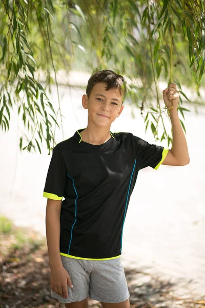 Teenage boy in street wear looking and smiling at the camera