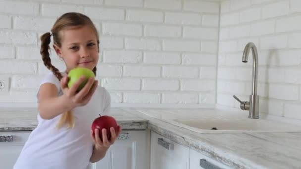 Little girl with apples fruit in kitchen. Copy space. — Stock Video