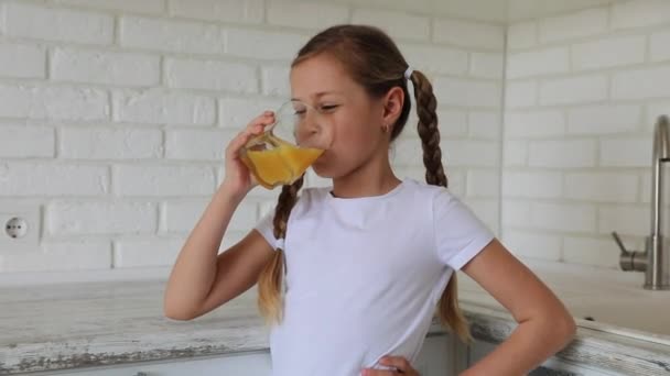 Good morning. little girl drinks juice. shows thumb up — Stock Video