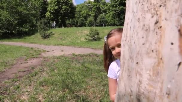 Barnet Tittar Och Gömmer Sig Bakom Ett Träd Flicka Spelar — Stockvideo