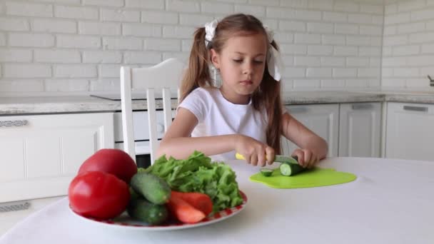 Little Girl Cuts Cucumber Child Preparing Green Salad Kitchen Girl — Stock Video