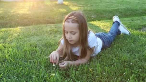 Happy Little Child Girl Lying Green Grass Outdoors Summer Park — Stock Video