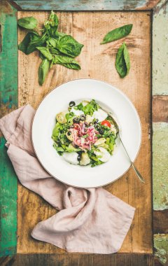 Enginar, zeytin, peynir ve rustik ahşap tepsi arka plan üzerinde beyaz tabak içinde kırmızı soğan taze yeşil yaz salatası