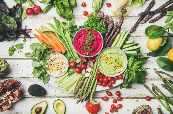 Healthy raw summer vegan plate on white table background