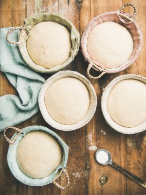Sourdough for baking homemade wheat flour bread in baskets clipart