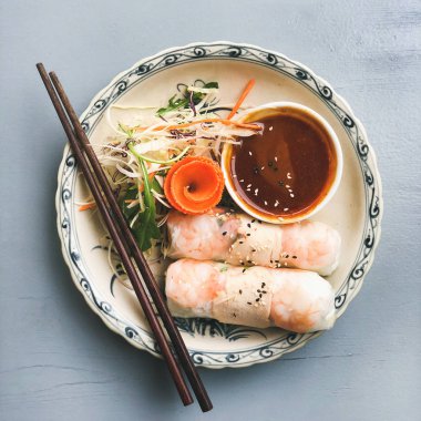 Mavi Masa üzerinde kase karides ve teriyaki soslu yaz pirinç kağıdı rulo