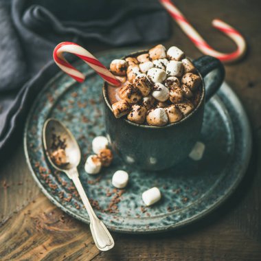 Winter warming sweet drink hot chocolate with marshmallows and cocoa in mug with Christmas holiday candy cane, selective focus, copy space, square crop clipart