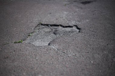 Kırık asfalt ve yol yüzeyindeki çatlaklar.