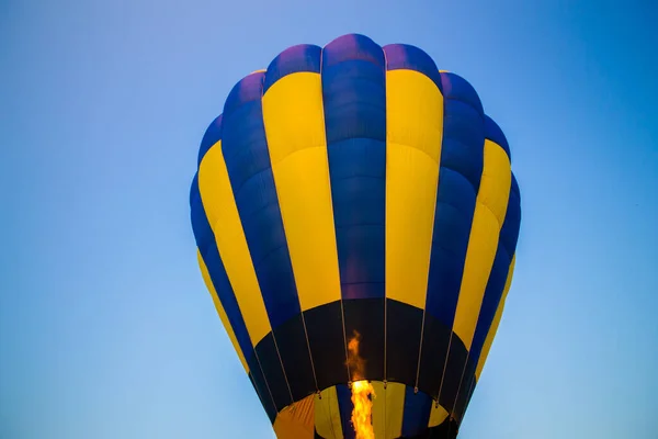 Big balloon flies against the sky