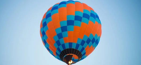 Big balloon flies against the sky