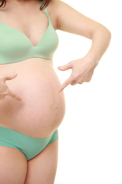 Kobieta Ciąży Wskazująca Żołądek — Zdjęcie stockowe