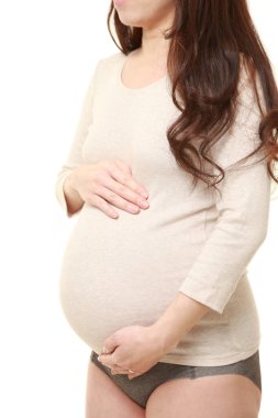  Kadın büyüyen hamile karnına dokunuyor.