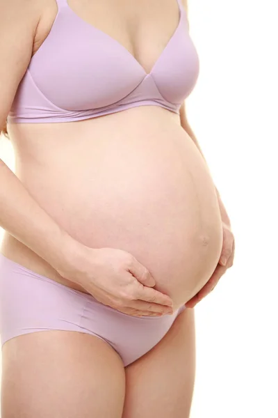 妊娠中のお腹に触れた女性は ロイヤリティフリーのストック画像