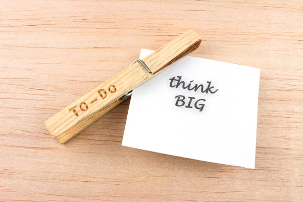 top view of to-do clothespin with think big note on wooden background