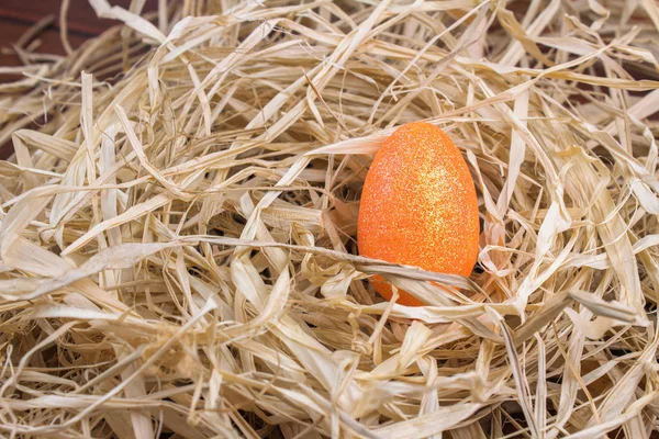 Glittered orange Easter Egg in a Nest