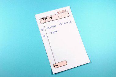 close-up shot of restaurant check list on blue background