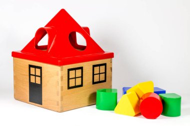 close-up shot of wooden house toy on white background