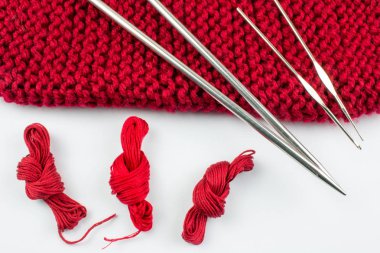 Pişmiş toprak örgü iğneleri, konu ve beyaz arka plan üzerinde izole eşarp