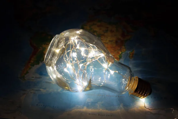 Light Bulb on World Map Background.