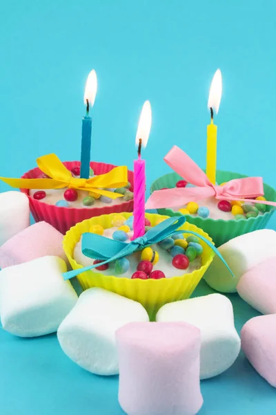 香草结霜的纸杯蛋糕与生日蜡烛和棉花糖 — 图库照片