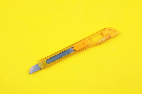 Yellow Plastic Cutter Paper Background — Stock Photo, Image