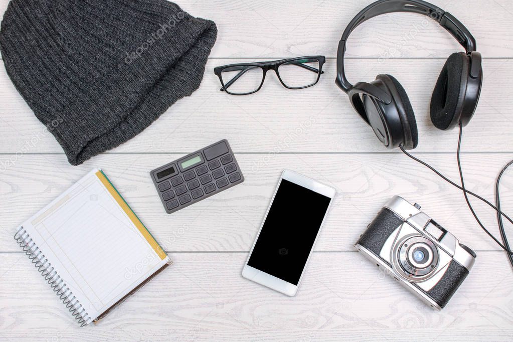 top view of business supplies and gadgets on white wooden table