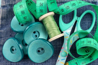 kot arka plan üzerinde plastik düğmeler, konu, makas ve ölçüm bandı Üstten Görünüm