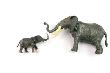 close-up shot of plastic toy elephants on white background