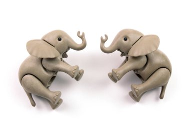 close-up shot of plastic toy elephants on white background