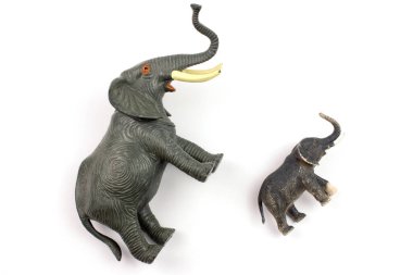 close-up shot of plastic toy elephants on white background
