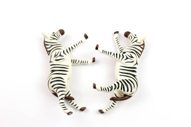 close-up shot of toy zebras on white background