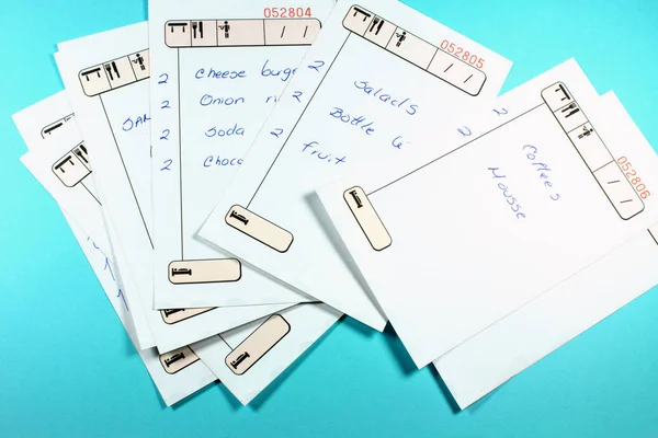 close-up shot of restaurant check lists on blue background