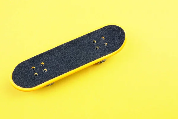 黄色の背景にミニのスケート ボード グッズ — ストック写真