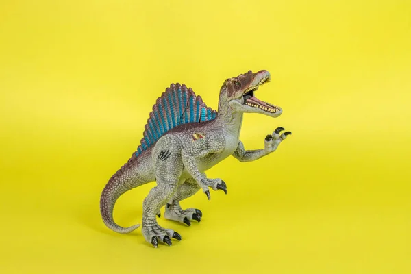 Dinosaur Plastic Toy in Yellow Background.