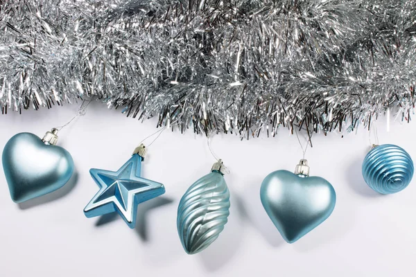 Christmas silver Tinsel and blue Balls isolated on white background