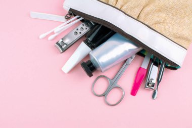 Manikür ve pedikür araçları pembe bir arka plan üzerinde