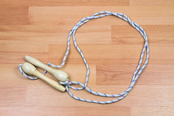 close-up shot of jumping rope on wooden floor