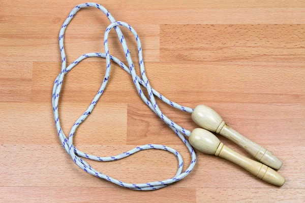 close-up shot of jumping rope on wooden floor