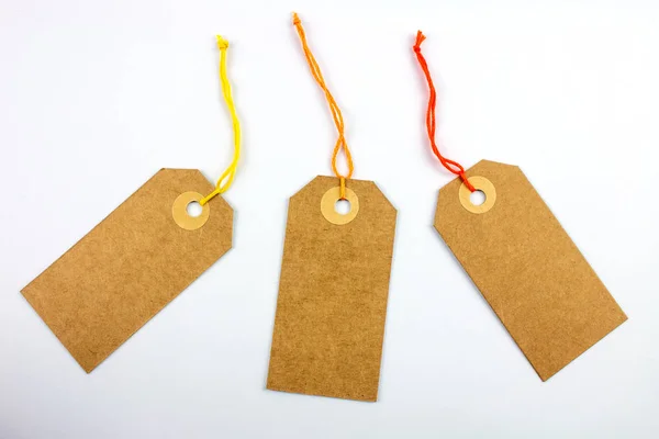 cardboard tags tied with strings isolated on white