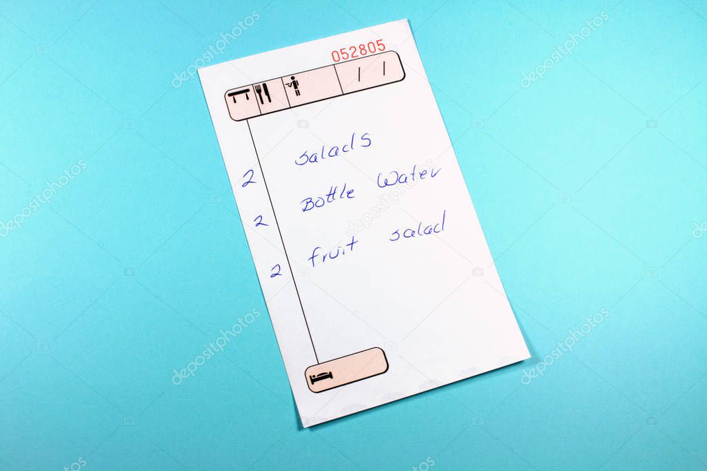 close-up shot of restaurant check list on blue background