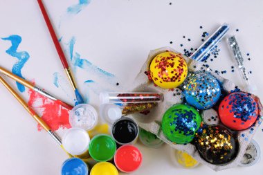 Boyalar, parlak ve fırçalar ile beyaz tablo Easter Eggs boyalı