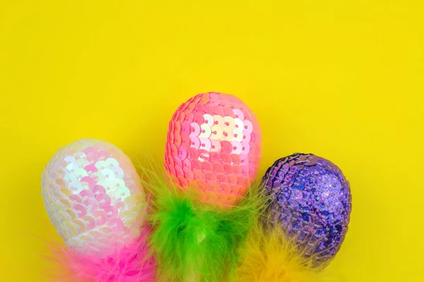 Colorful Sequins Easter Eggs Feathers Yellow Background — Stock Photo, Image