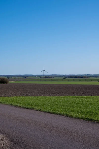 A single wind turbine stands tall in the flat farmlands of Skane (Scania) in southern Sweden