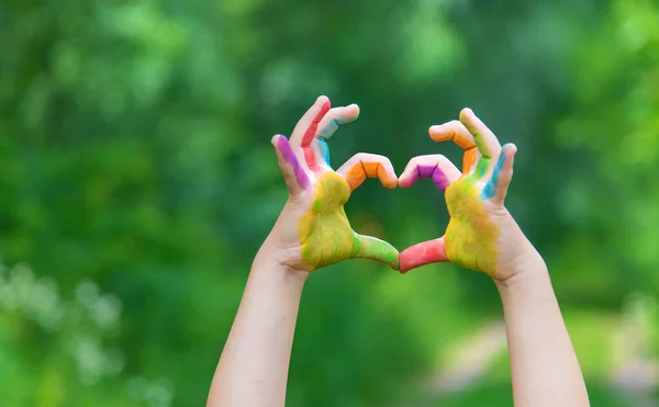 Children\'s hands in the colors of summer. Selective focus.